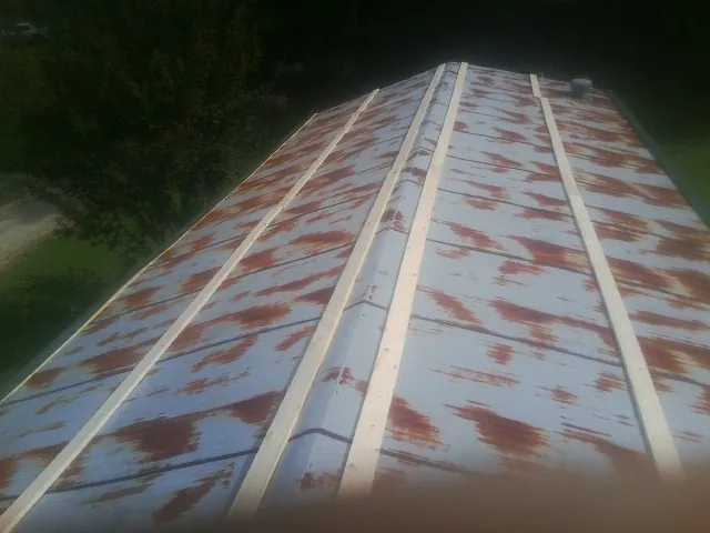 Rusted metal roof panels with new wood purlins before replacement — Storm Damage Roof Repair in Franklin by Roofing Brothers